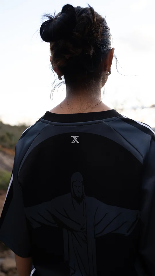 Back detail of a dark graphic T-shirt worn outdoors.