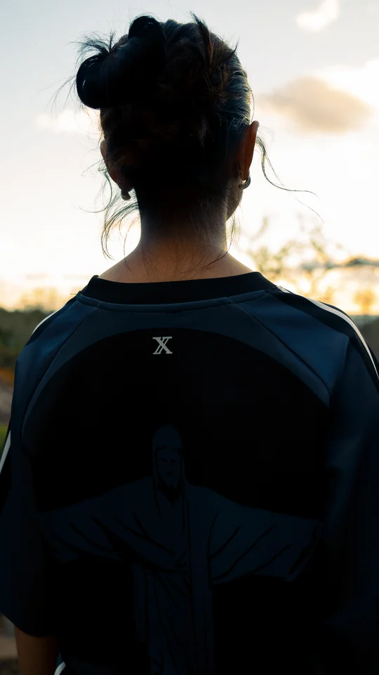 Back detail of a dark graphic T-shirt worn outdoors.